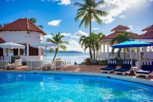 pool deck with views across the sea at Windjammer Landing Villa Beach Resort