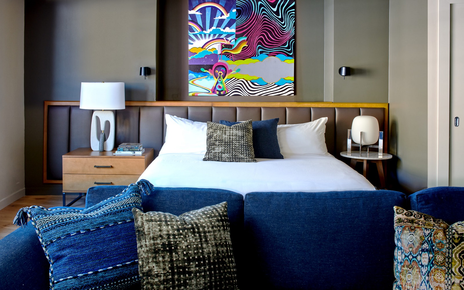 colourful painting and blue sofa in the guestroom at Hotel Ziggy in Los Angeles