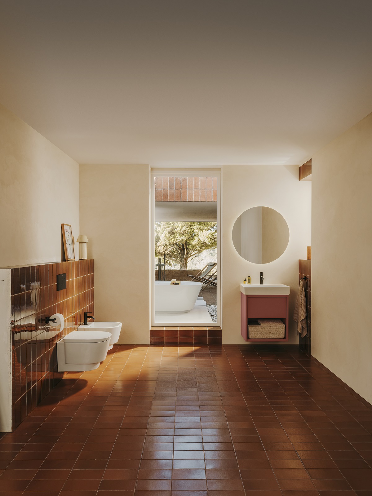 terracotta floor tiles leading out to outdoor bath in Mediterranean inspired bathroom by Roca