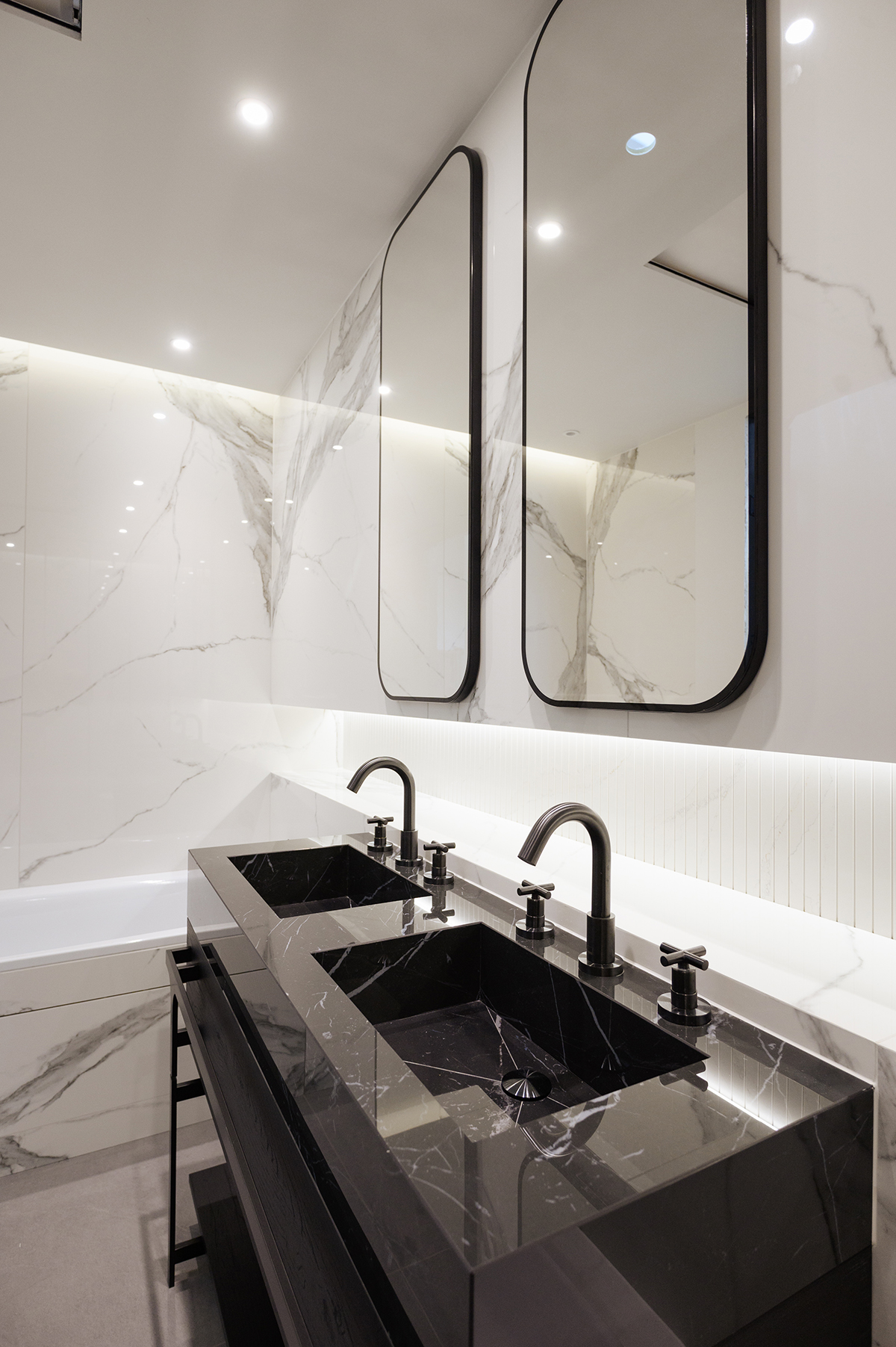 double mirrors above double vanity in bathroom pod designed by StoneBathwear