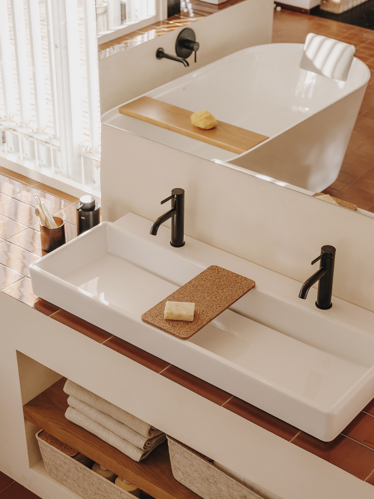 square basin and wood and cork accessories on vanity with Tura fittings by Roca