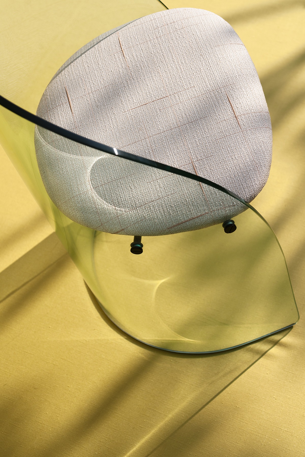 clear perspex chair with cream Dedar fabric on bright yellow background