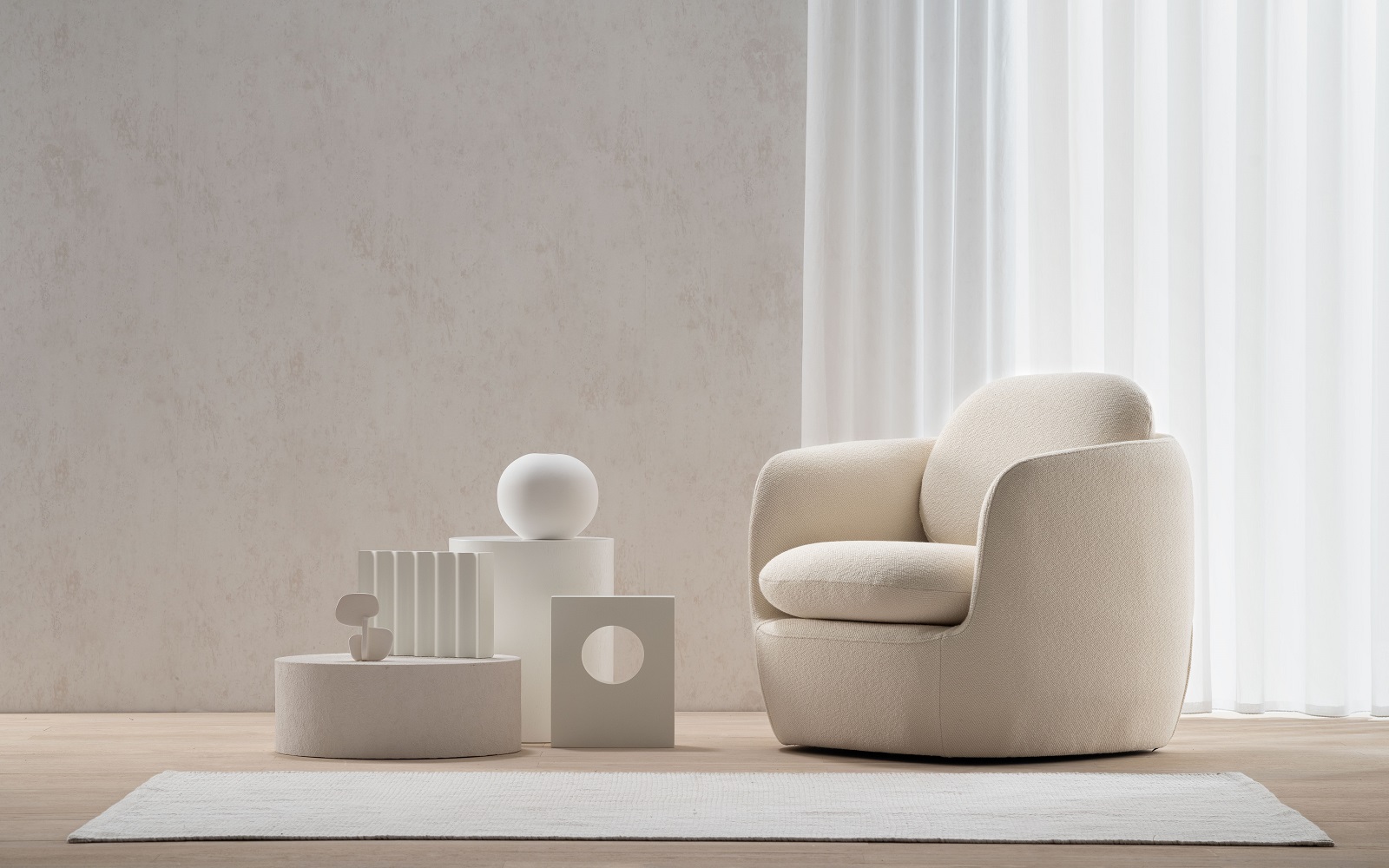 white rounded upholstered chair in a white room with white sculptural objets with Bilbao Chair from Morgan