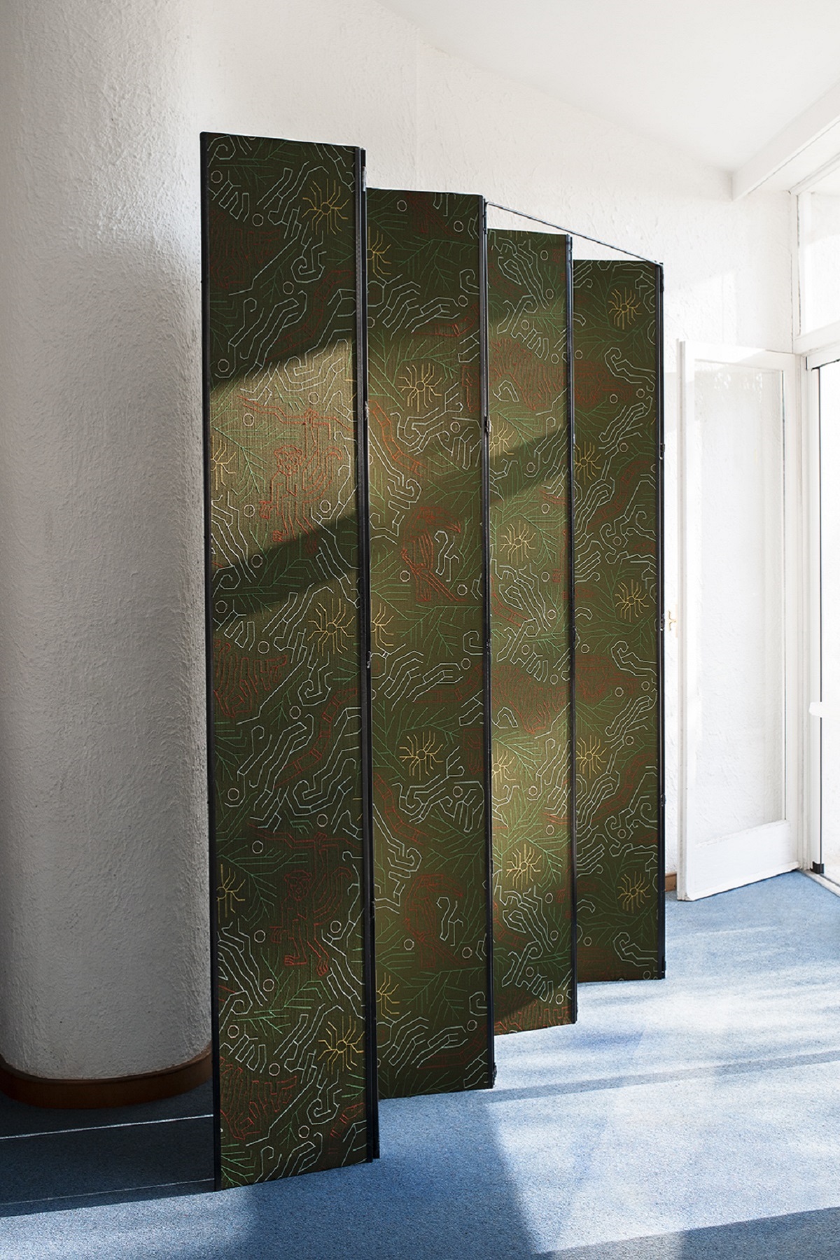 concertinaed panels of Dedar fabric on blue floor