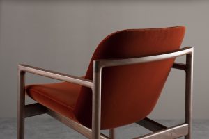 wooden frame detail and rust upholstered seat of Rakino chair by Morgan