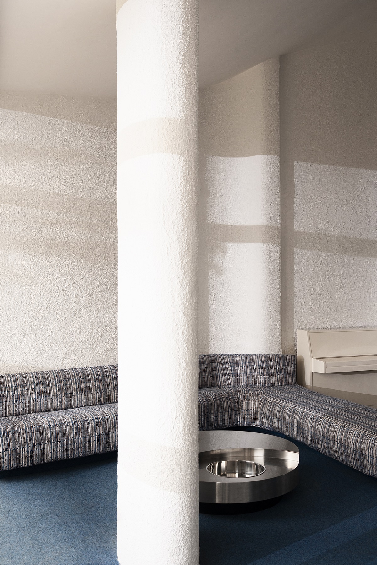 grey Dedar fabric on seating in white room with blue floor