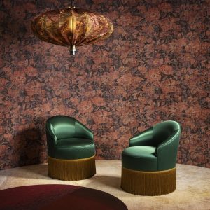 green satin chairs with gold trim in front of bronze and gold decorative Antigua wallcovering by Arte