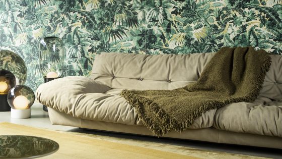 cream puffy couch with green woven throw in front of textured green anitgua Tropicali wall covering by Arte