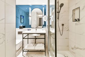 marble surfaces and a blue wall in bathroom at Lost Property designed by Ica