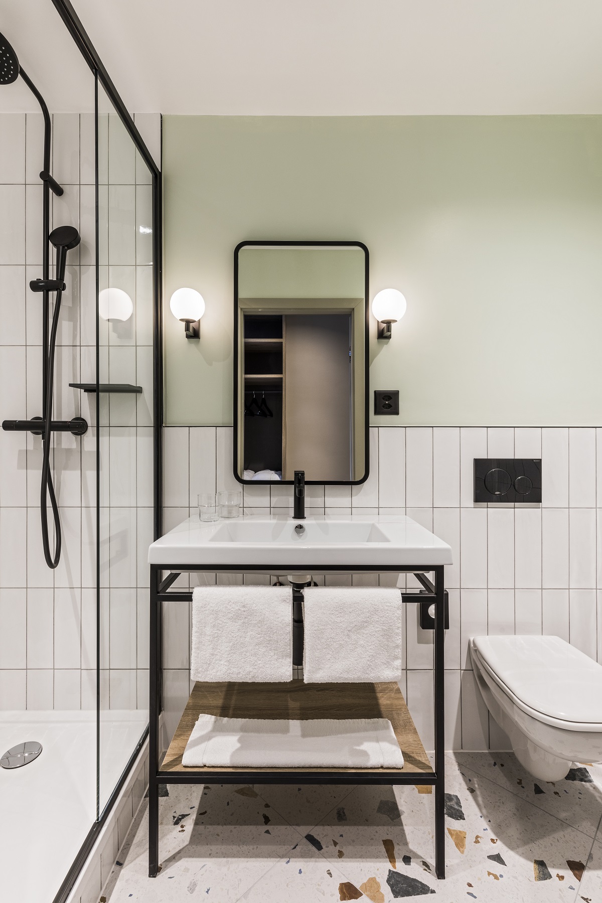 black and white bathroom design with terrazzo floor