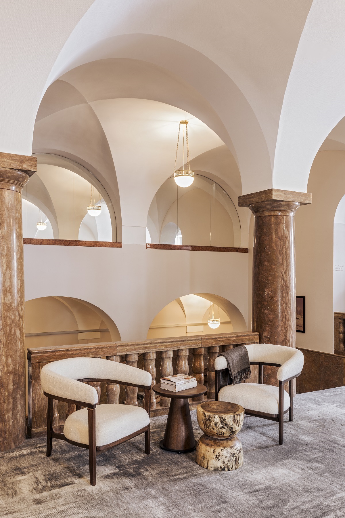 curved ceiling arches and curved cream chairs in the Faern Arosa Reception