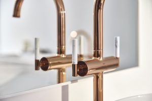marble caesarstone detail on tap handle of GROHE Atrio gold tap mixer