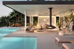 modern house with outdoor seating and Gyrofocus fireplace alongside the swimming pool