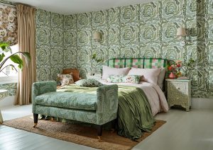 white wooden floors with green patterned wallpaper behind a bed with green fabric from Harlequin range colour4 