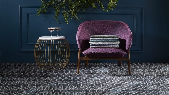 dark blue wall, patterned carpet and purple chair in madurai fabric by skopos