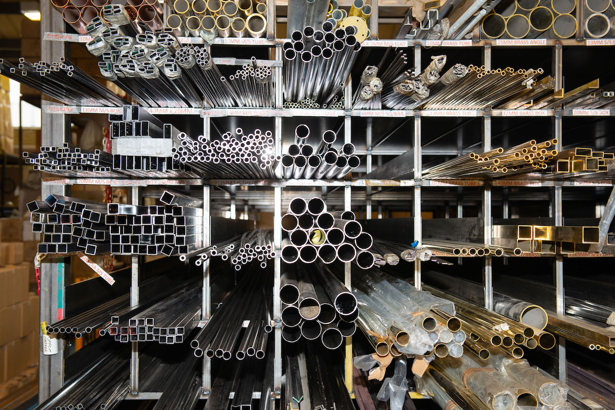 Piles of metal pipes in factory