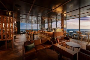glass windows overlooking the city in the rooftop bar in voco Auckland