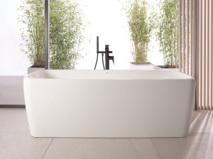 freestanding Qatego bath designed for Duravit by Studio Porsche in front of window and on a stone floor