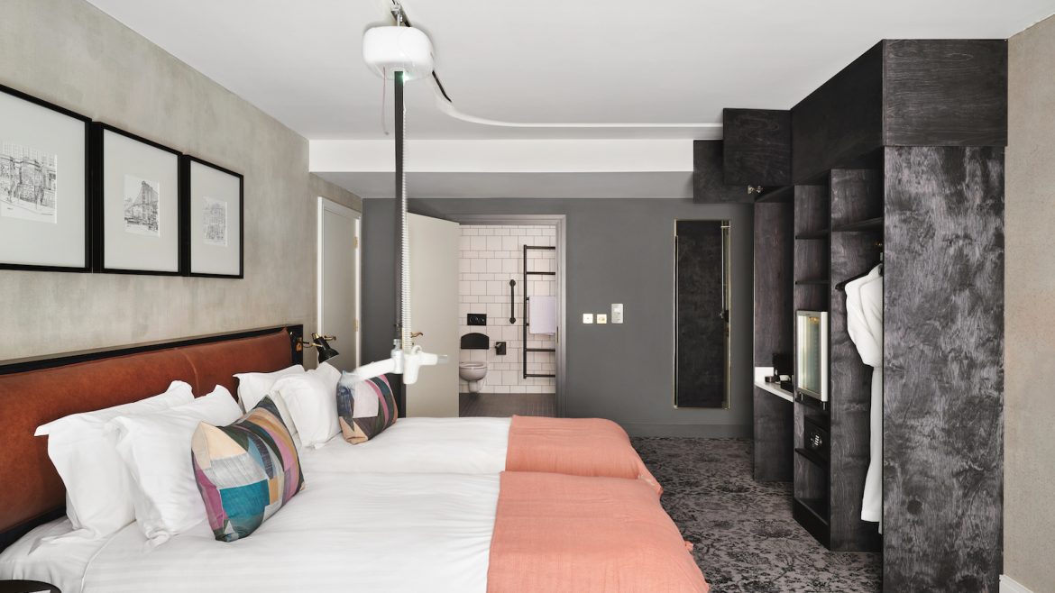 An accessible guestroom inside Hotel Brooklyn, with extendable hoist above bed