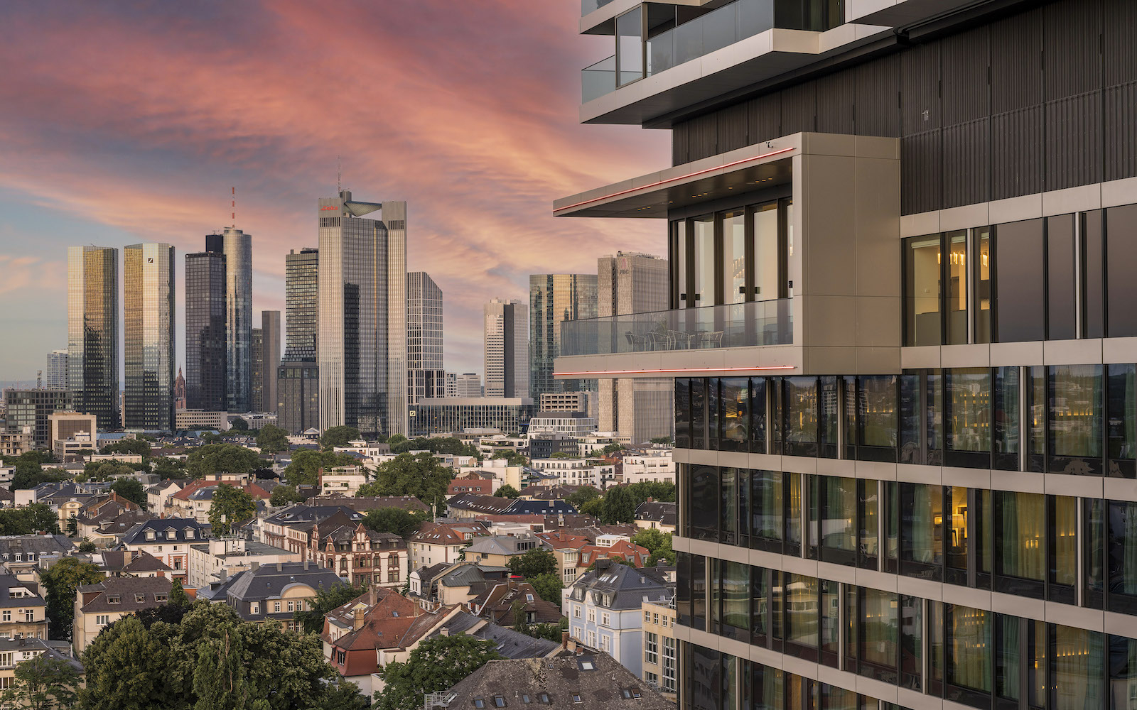 Exterior of Melia Frankfurt City showing corner of balcony and city skyline