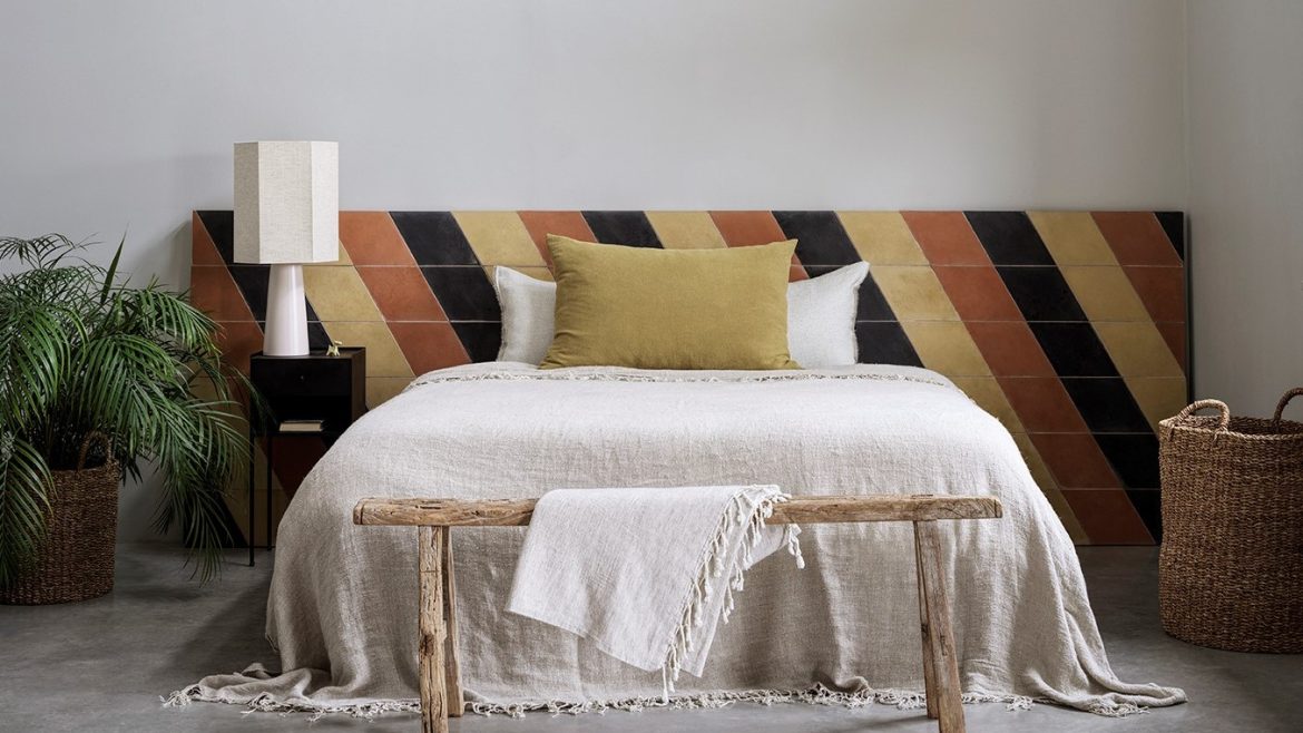 brown and black striped tile as headboard behind the bed. Bert & May encaustic tiles from Hyperion Tiles