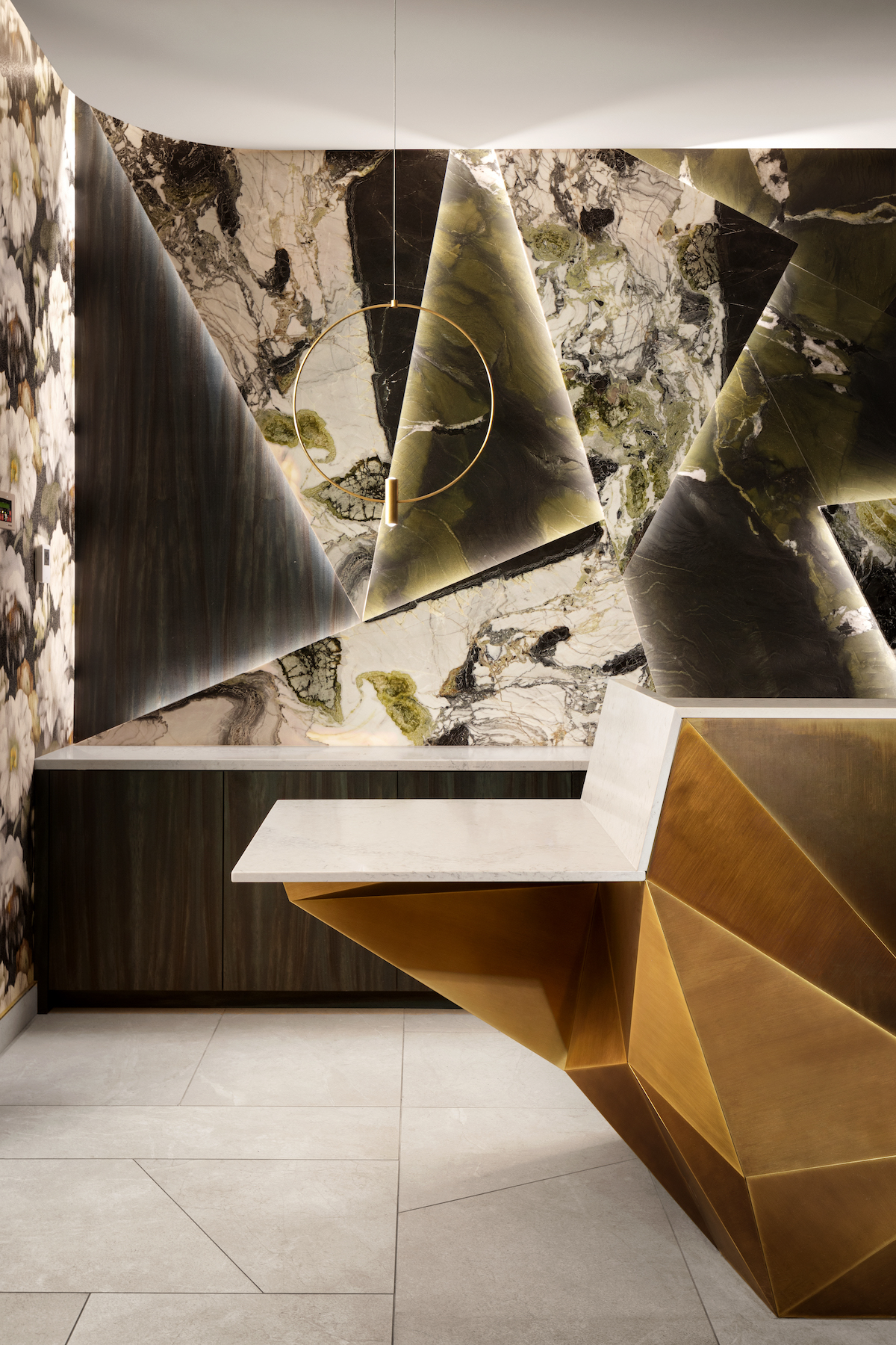 Close up of geometric lobby desk and maximalist wallpaper