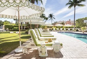 lime green and white parasols and sunloungers around the pool at The Colony