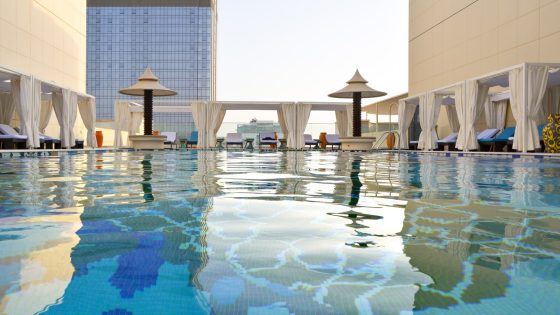 view across swimming pool with mosaic arabesque tiled floor at the Andaz Dubai