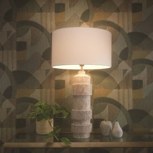 mood lamp on a table with textured ceramic base and deco patterend wallpaper in the background - Denali table lamp by northern Lights