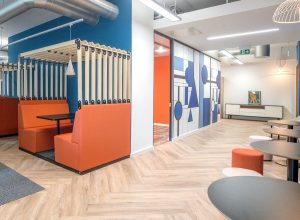 blue and orange zoned working space with statement design print on walls in blue and white by Newmor