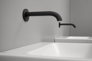 sideview of matt black wall mounted tap over basin from Geberit