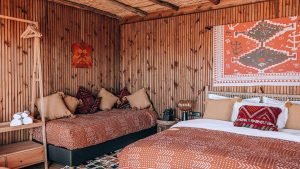 wooden panelled walls, artisanal textiles and patterns in the moroccan styled Selina Dakhla