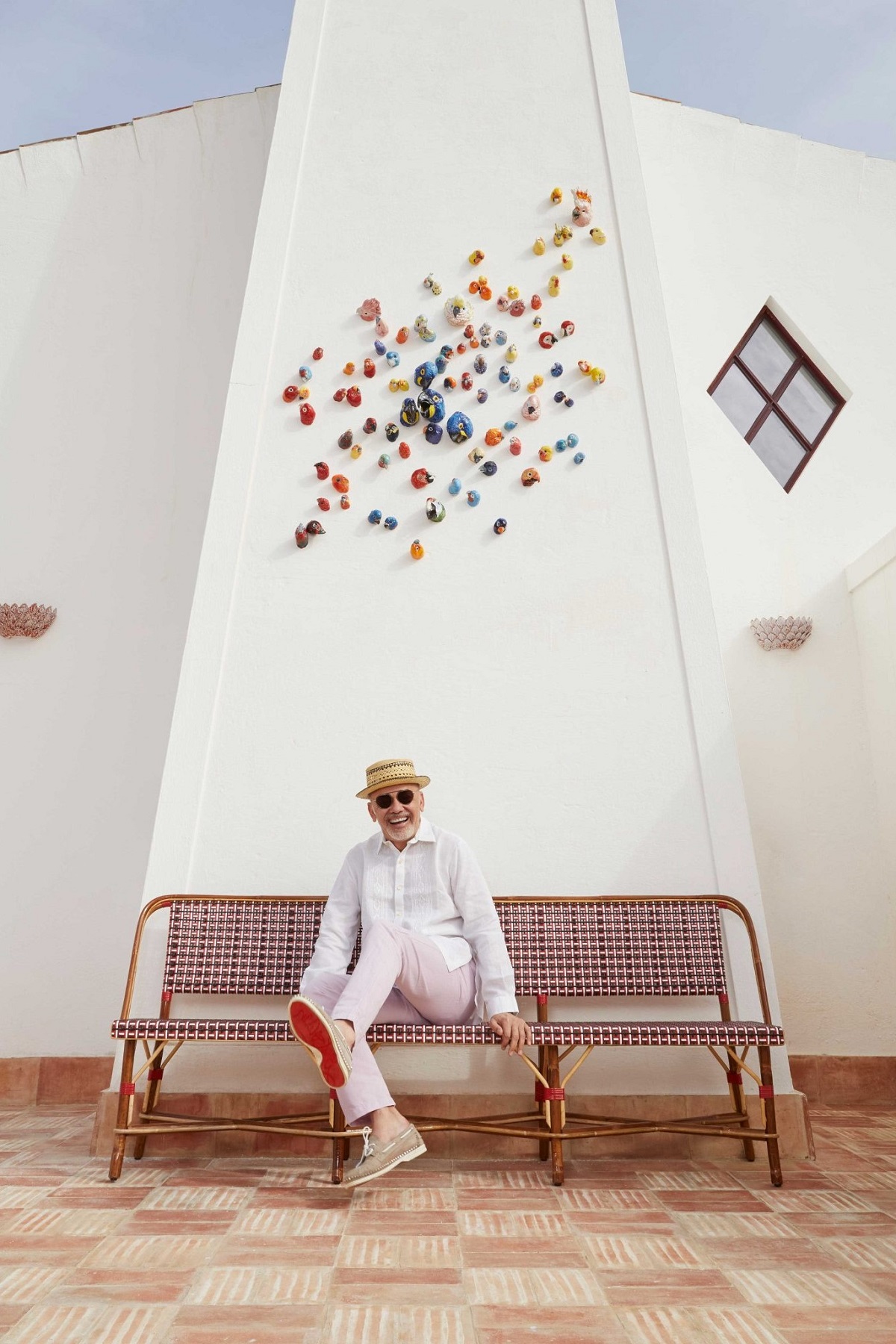 portrait of Christian Louboutin in front of the hotel Vermelho Marugal