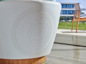 white leather and wood chair detail with mayan inspired circular motif by Chapi chapo design