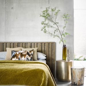 wooden headboard and tables with plants add notes of biophilic design to the hotel guestroom with bed design by sofa.com