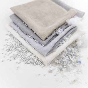 swatches of cream, beige and grey recycled Edmund Bell Sway fabric with plastic beads