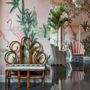 flamingo and palm tree wall murals, rattan chair and pink walls in the lobby at The Colony
