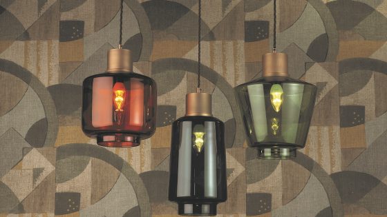 coloured glass pendant range of lights against art deco wallpaper. Lights in the Levit, Warner & Romney glass pendant ranges by Northern Lights