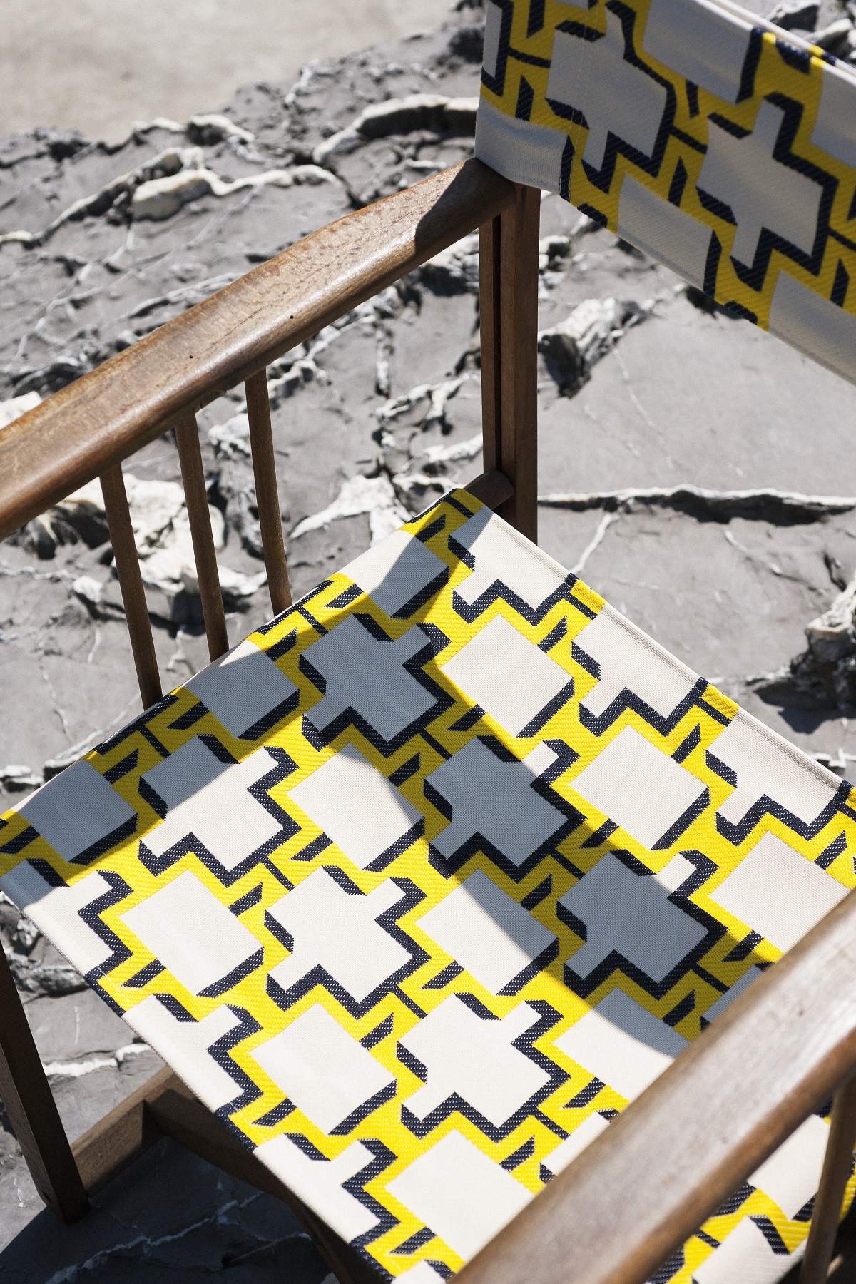 lozenge design in yellow and black fabric on seat of deckchair from Dedar Enjoyable Outdoors Collection
