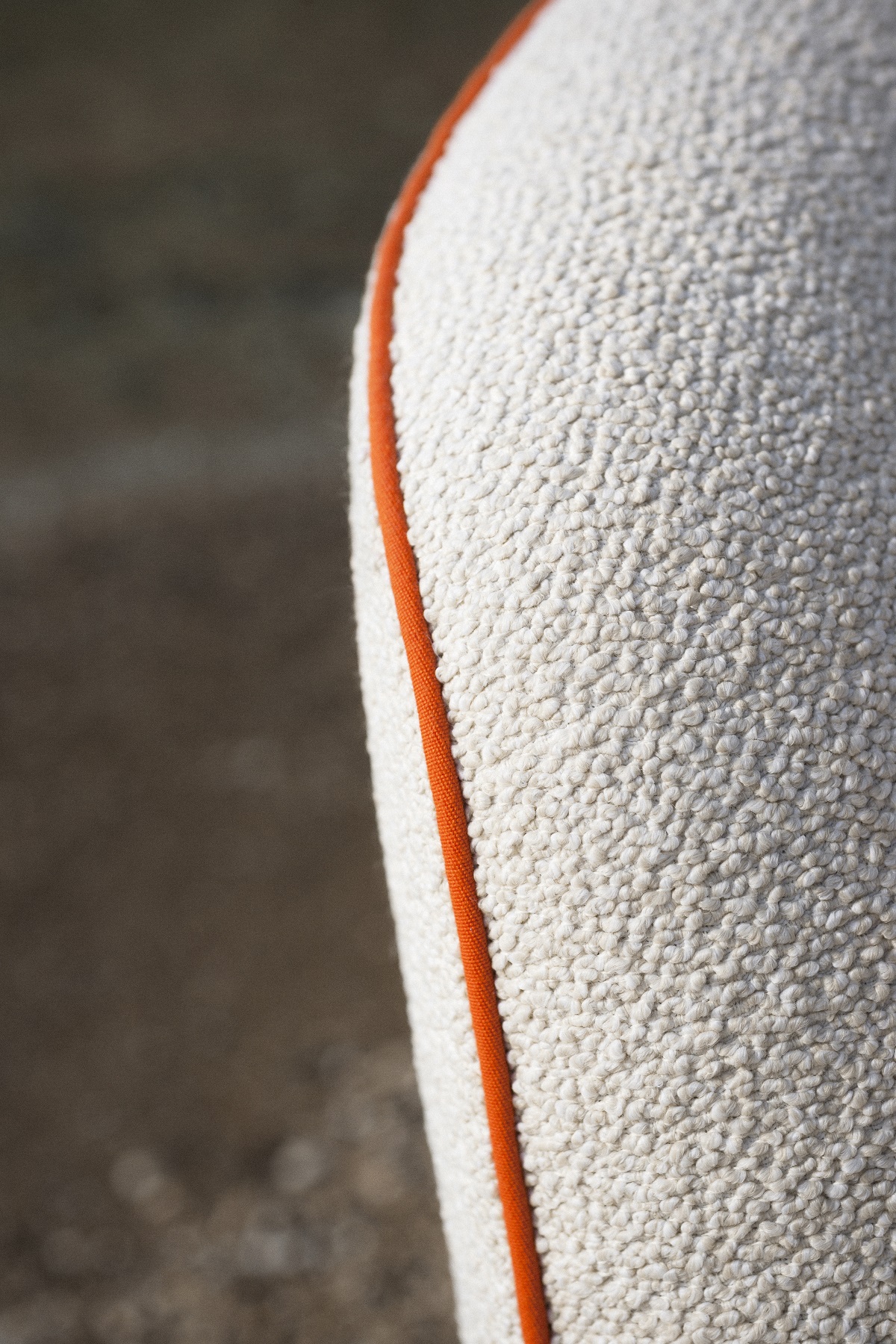 detail of chair edge upholstered in Libera boucle from Dedar