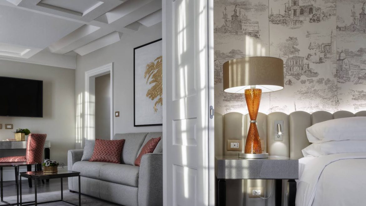 A luxury suite in Venice, with living room and bedroom in soft interiors