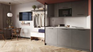 kitchen area next to round table and chair and wardrobe in apartment style hotel room in Bob W