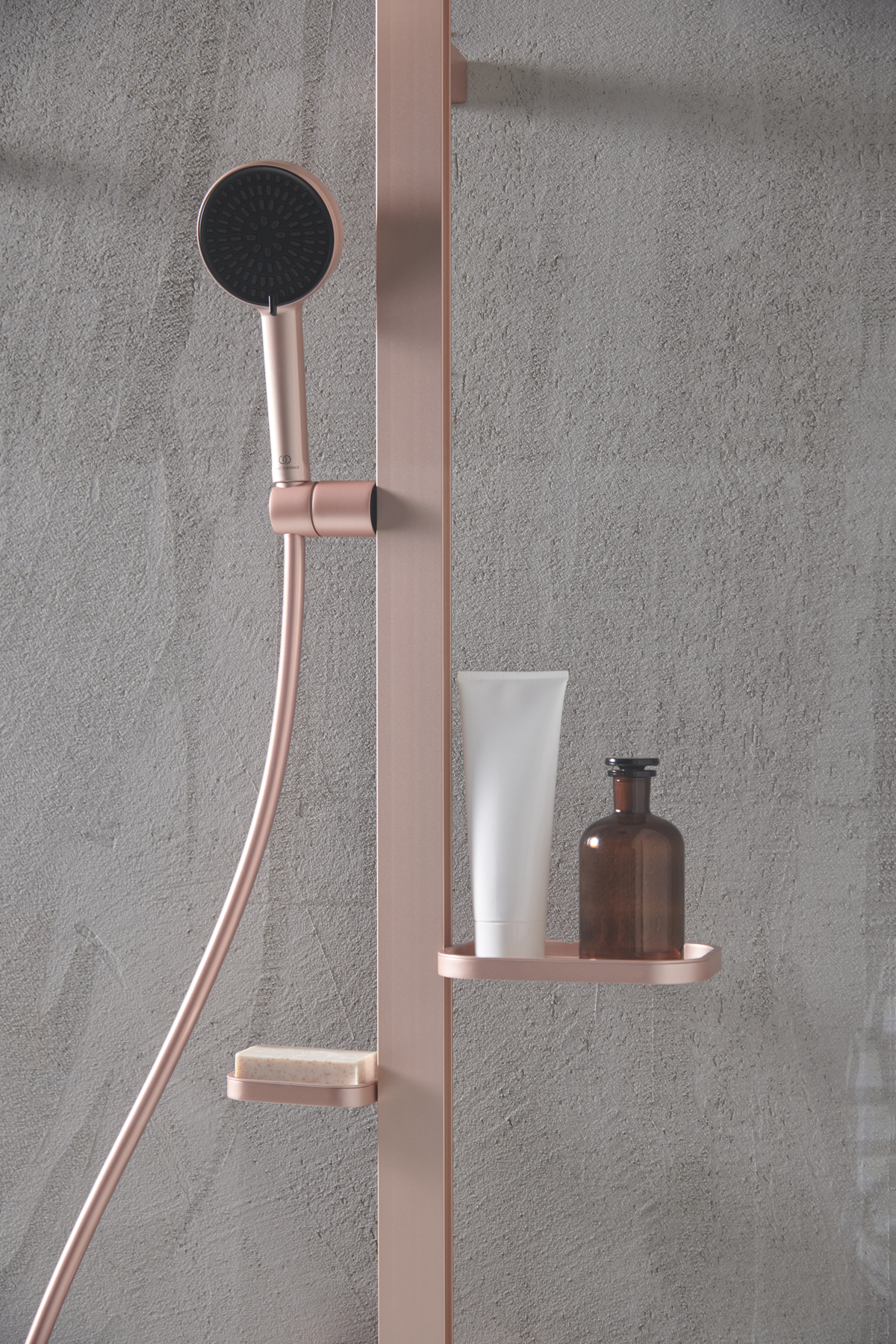 rose gold shower unit with shelving integrated for bottles and shampoo