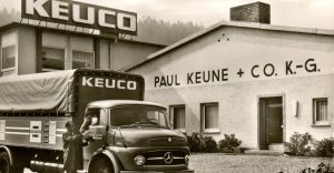 old sepia photograph of original KEUCO factory with branded van