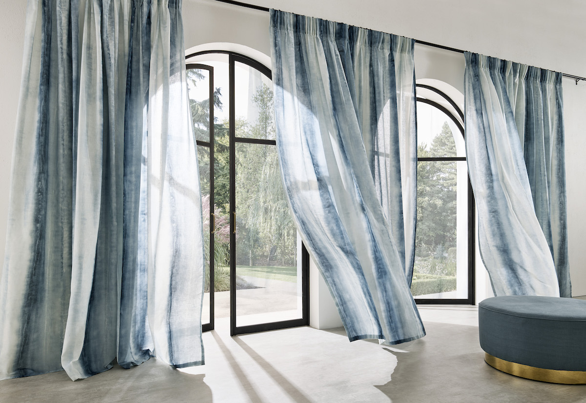 Blue silk curtains blowing in the wind