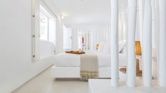 white interior in guestroom with white painted wood, cream floor, white linen and white walls in Octant Vila Monte