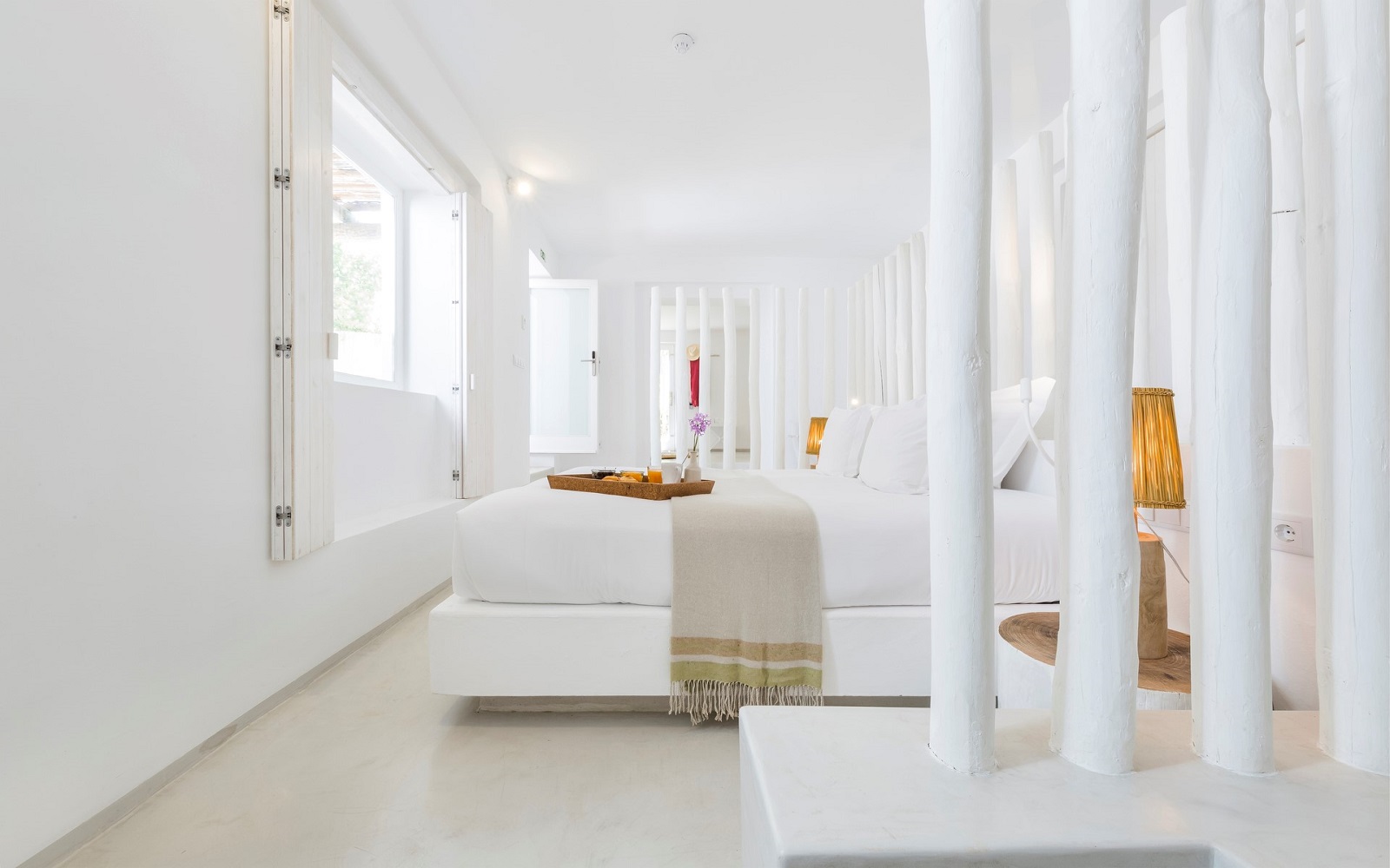 white interior in guestroom with white painted wood, cream floor, white linen and white walls in Octant Vila Monte