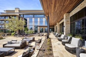 ranch style patio with wood and stone surfaces running along the length of Omni PGA Frisco Resort