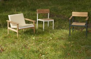 a selection of three outdoor chairs from Fritz Hansen placed on the grass