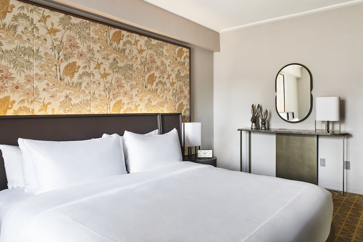 A large guestroom inside New York hotel, with botanical inspired wallpaper